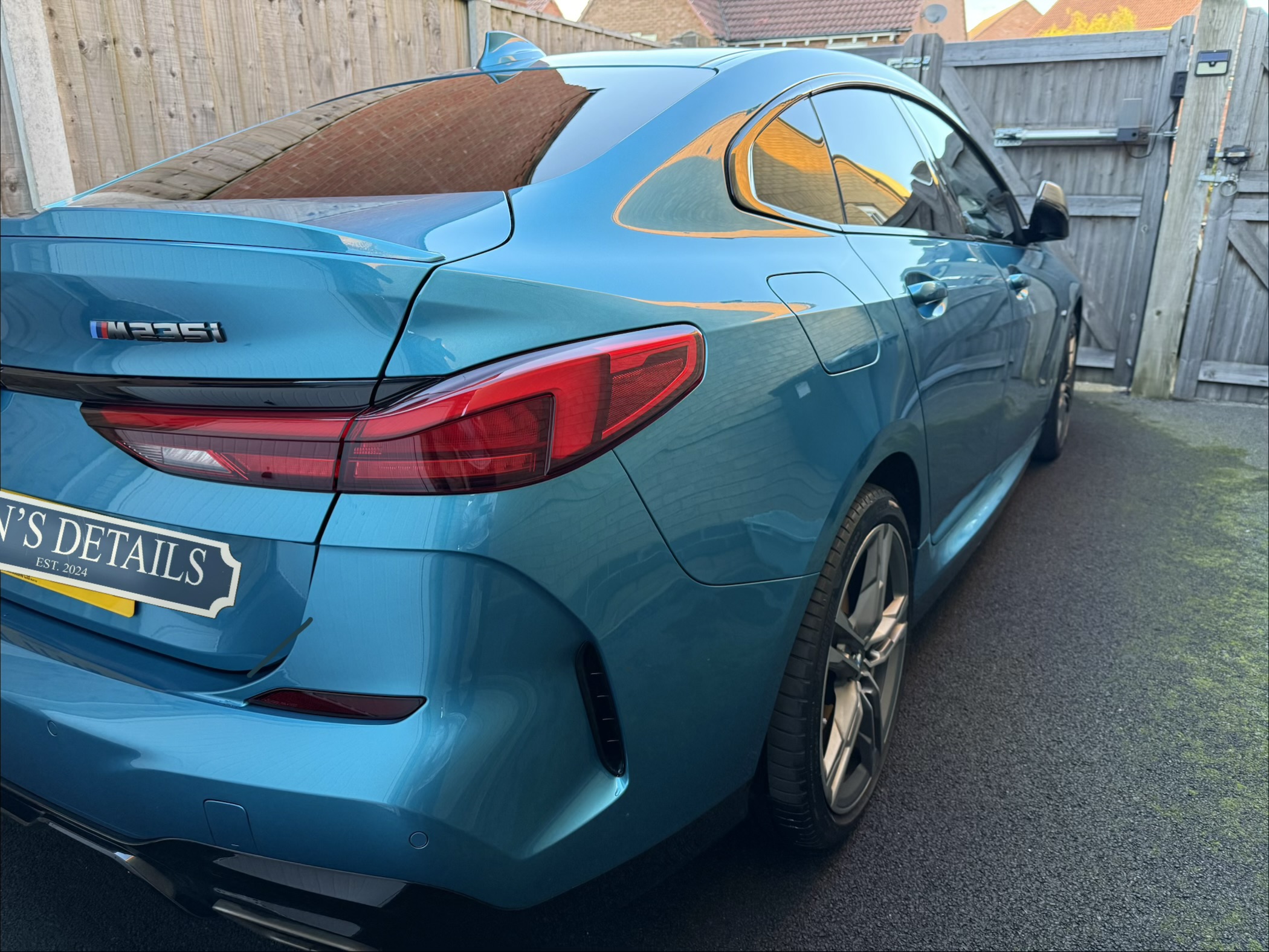 BMW 235i after detailing with a cleaner rear quarter and glass